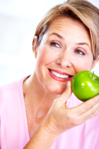 older woman with apple