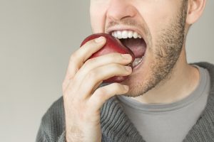 man eating apple