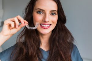 woman with invisalign aligners